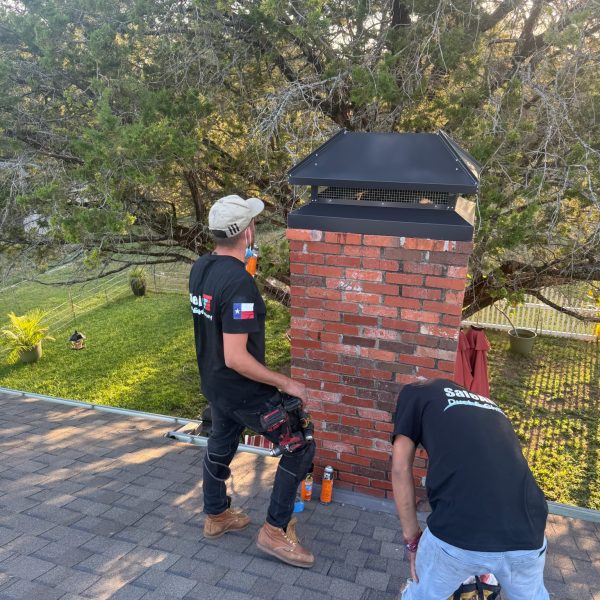 Chimney with a custom cap and red bricks in Fort Worth, Texas, repaired and rebuilt for durability.