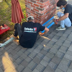 Comprehensive Chimney Services for Red Brick Chimneys in Garland, TX Chimney services in Garland, Texas, ensuring a watertight seal and protecting a red brick chimney from damage.
