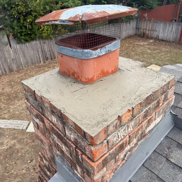 Chimney crown repair services with a chimney cap in Garland, Texas, ensuring safety and durability.