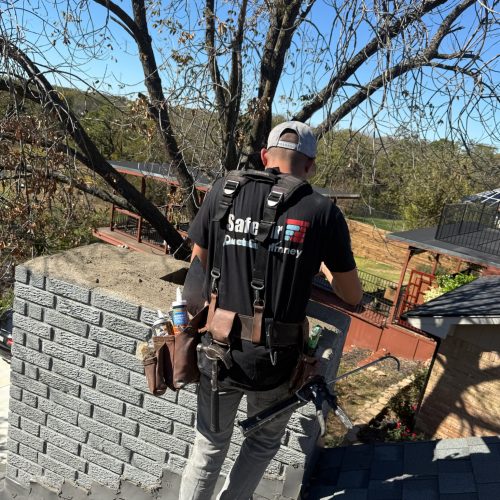 Chimney and fireplace services company performing maintenance on a gray brick chimney to enhance safety and functionality.