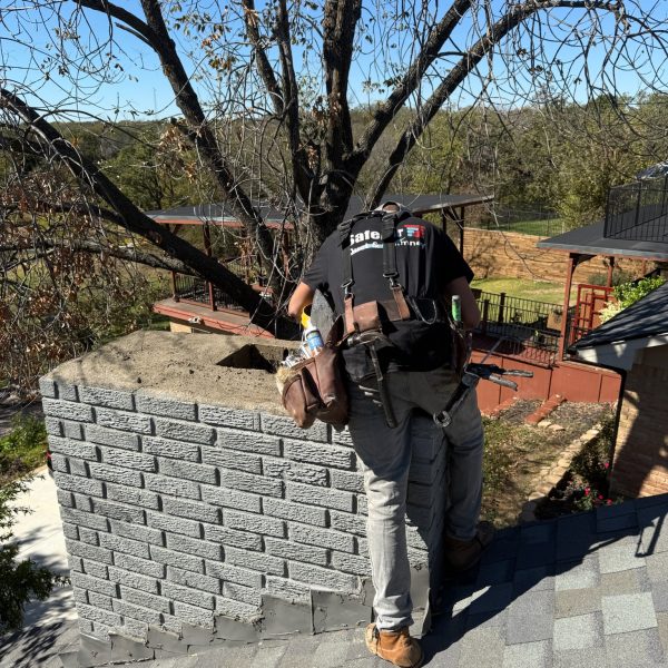 Damaged chimney receiving a crown repair by a professional chimney repair company in Arlington, TX, to prevent water damage and restore functionality.