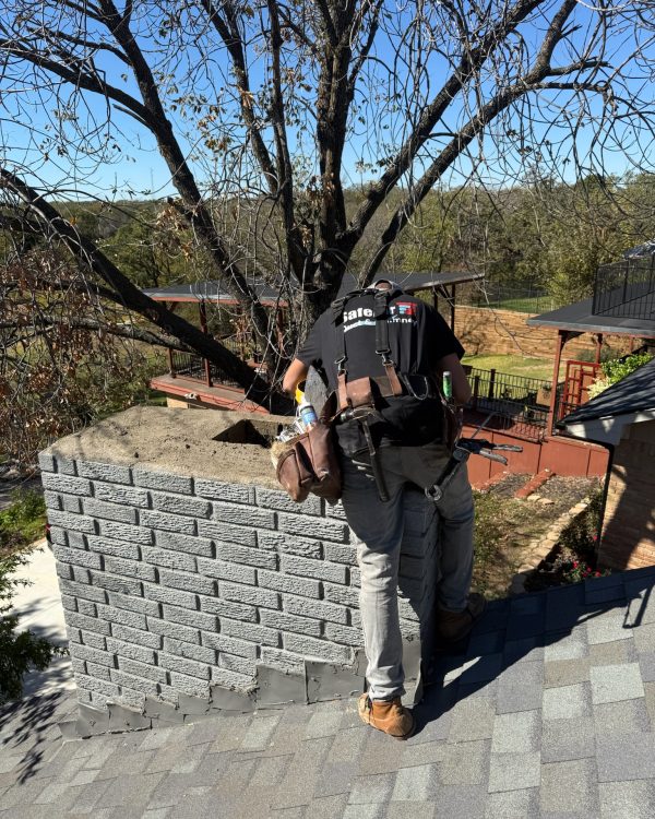 Damaged chimney receiving a crown repair by a professional chimney repair company in Arlington, TX, to prevent water damage and restore functionality.