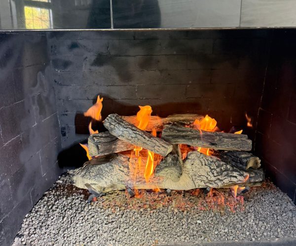 New gas logs set inside a gas fireplace in Dallas, Texas, creating a warm and inviting atmosphere.