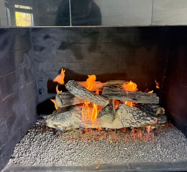 New gas logs set inside a gas fireplace in Dallas, Texas, creating a warm and inviting atmosphere.