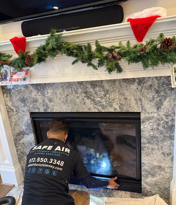 Chimney and fireplace company installing a new gas fireplace in Plano, Texas.