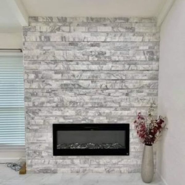 Newly remodeled fireplace installed on a white brick wall in Arlington, Texas, highlighting modern design and energy efficiency.