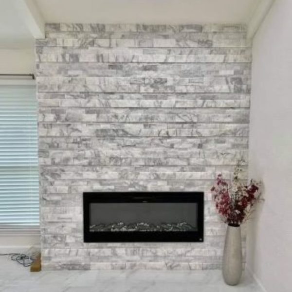 Newly remodeled fireplace installed on a white brick wall in Arlington, Texas, highlighting modern design and energy efficiency.