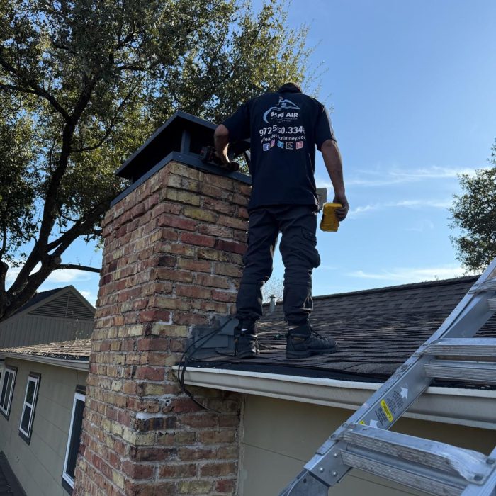 Chimney repair on a roof with red bricks in Dallas, Texas, restoring safety and functionality.