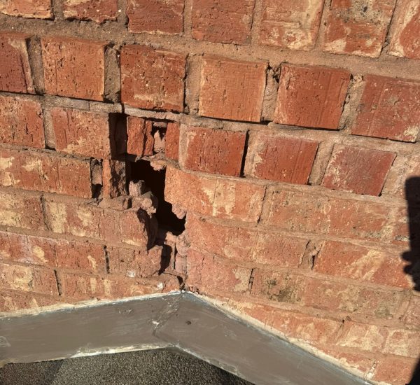 Cracked red chimney bricks in need of masonry repair to restore structure and durability.